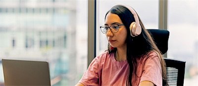 A support assistant focused on their work at a desk