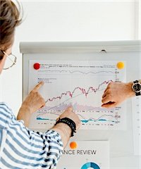 A person presenting performance results on a chart