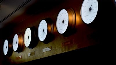 Clocks showing different time zones on an office wall