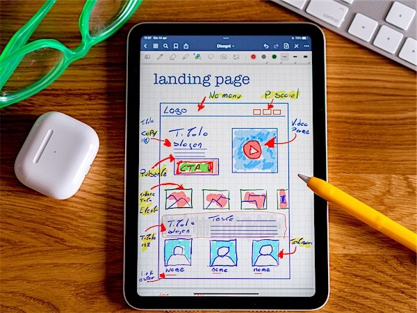 A landing page being sketched out as a wireframe on a tablet