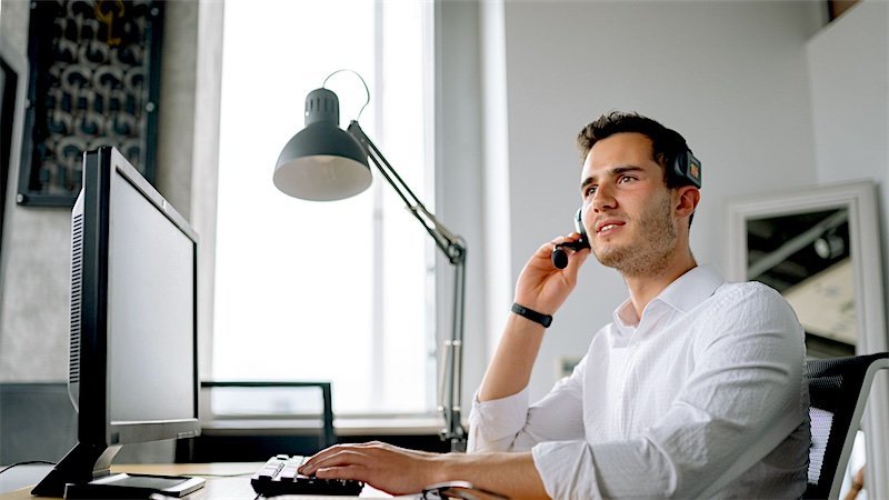A real estate professional making calls at their desk