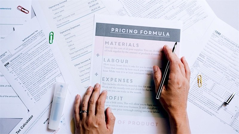 Pricing worksheets spread across a desk