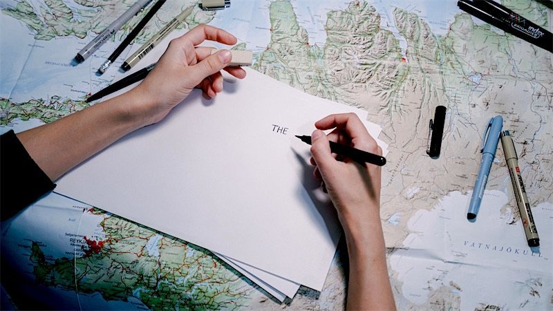 Travel planning with a map and notes on a desk