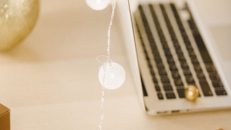A warmly lit desk with a small Christmas ornament, marking the start of the 'ber months